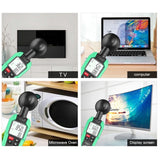 Hand holding a digital EMF meter to measure electromagnetic radiation from a laptop screen.