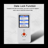 The handheld digital EMF meter, which displays readings on its bright color screen.