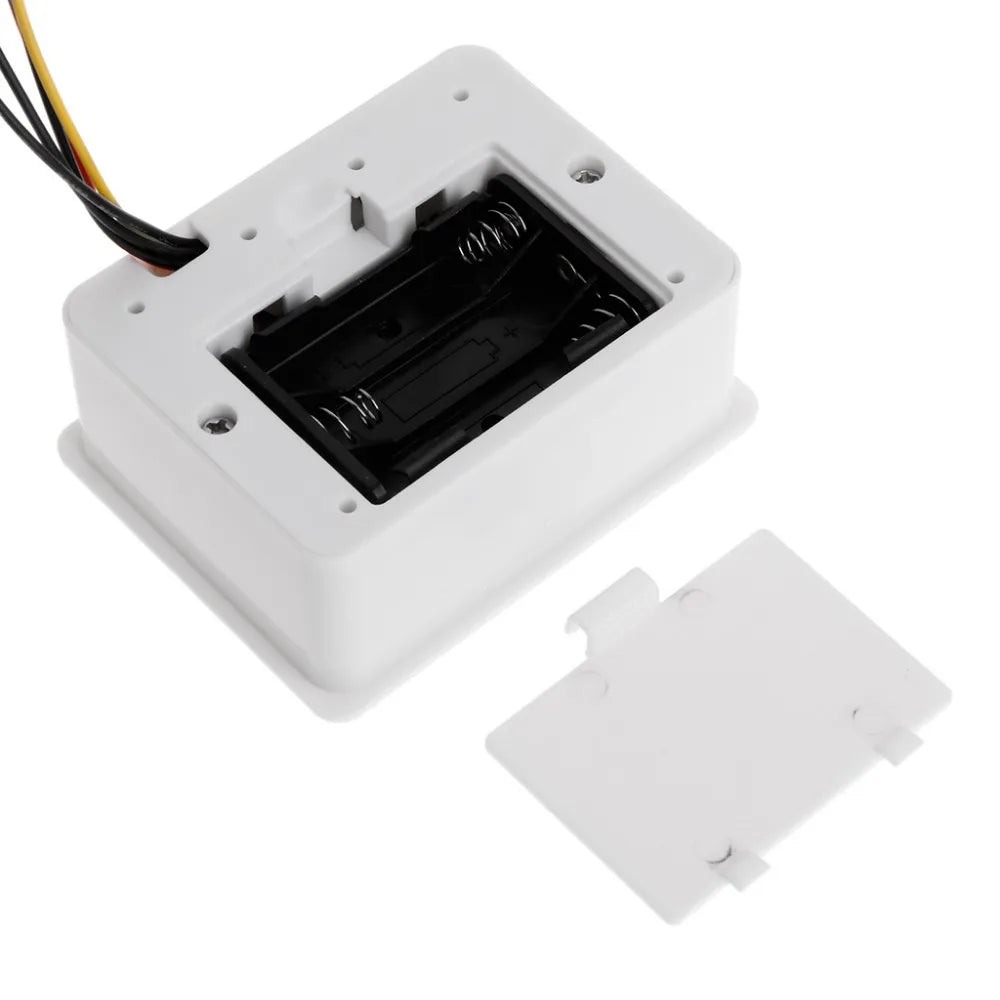 Back view of the digital display, showing the battery compartment and mounting points.