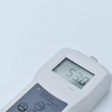 The UM6700 thickness gauge held in hand to show its compact and portable design.