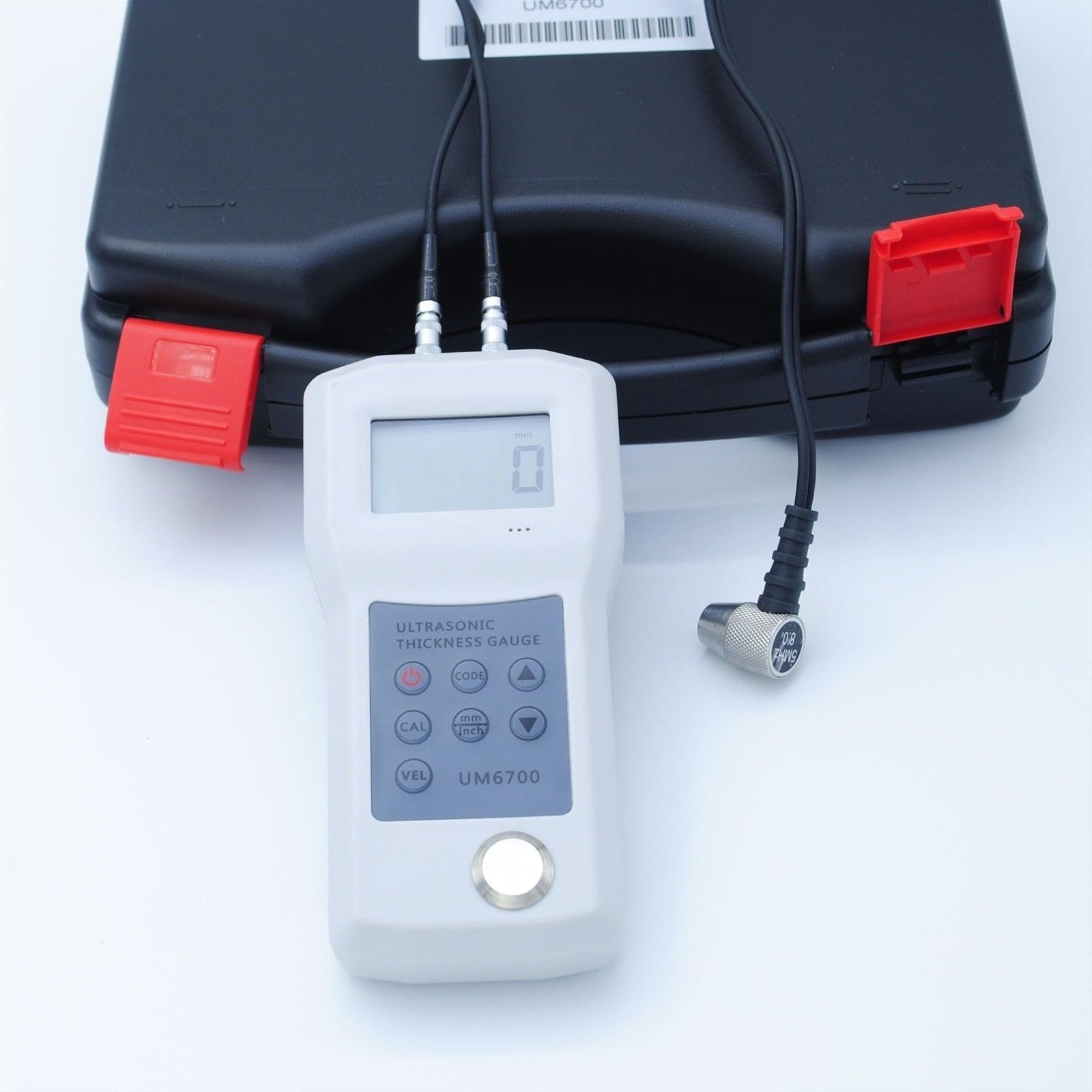The complete UM6700 kit, including the main unit, probe, and carrying case.