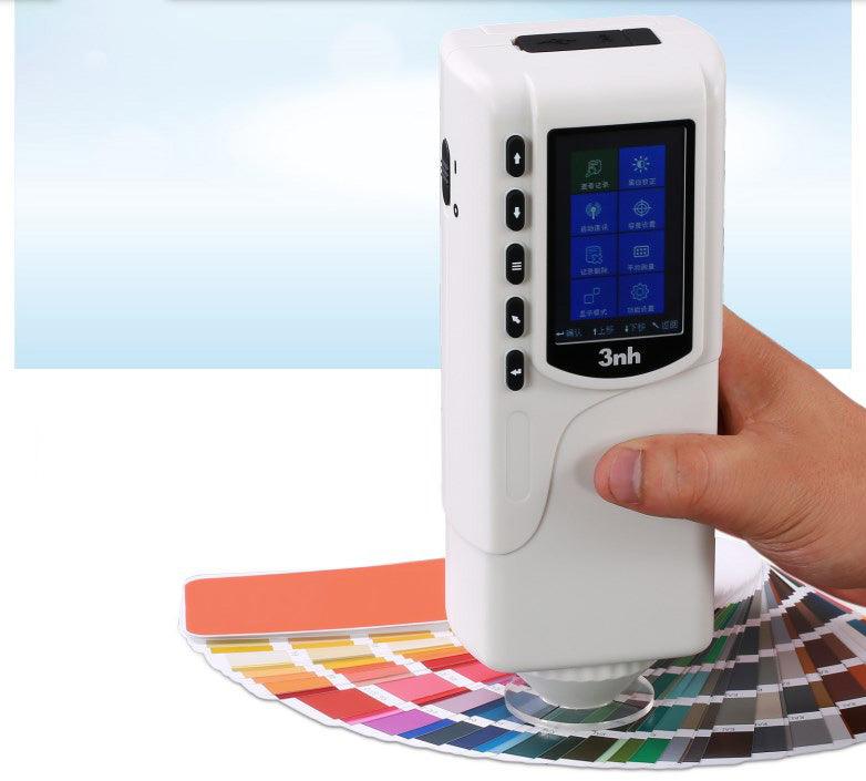 The NR60CP digital colorimeter being used to measure the color of a blue surface.