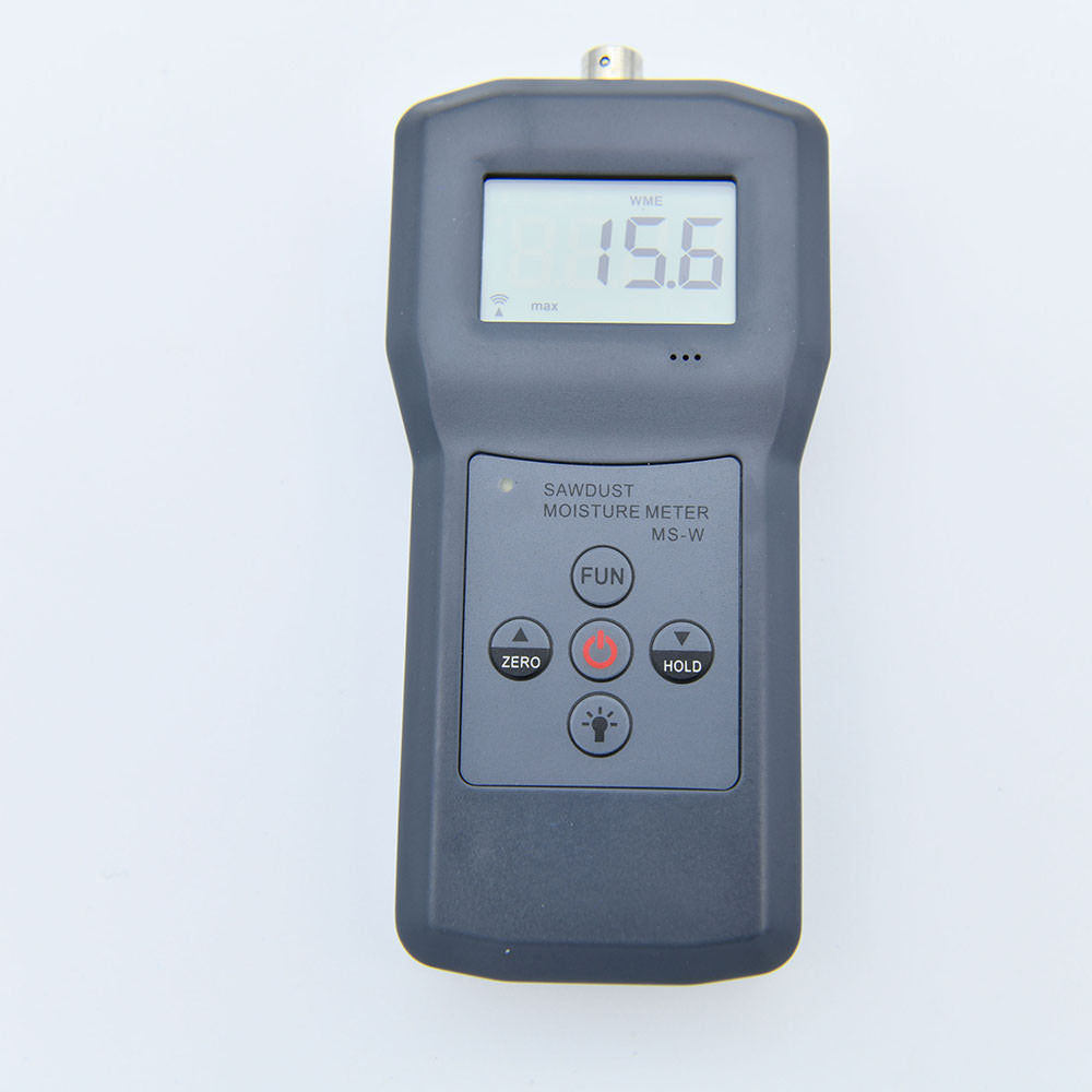 Close-up of the digital display on the sawdust moisture meter showing a reading.