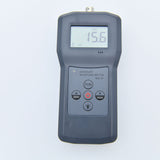 Close-up of the digital display on the sawdust moisture meter showing a reading.